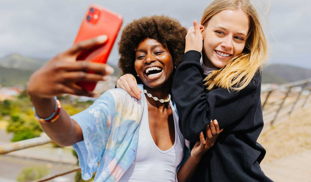 School friends taking a selfie for a yearbook.