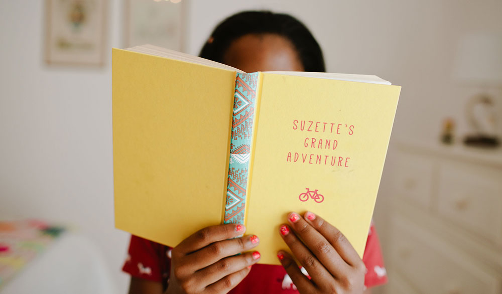 Young girl reading a children's book