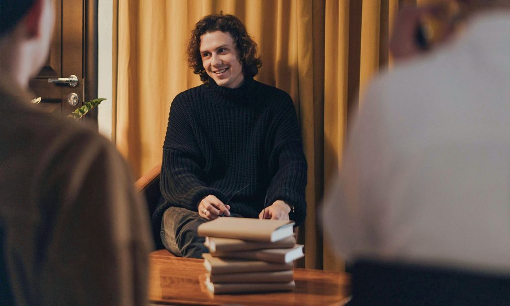 Writer signing books at a book promotion event.