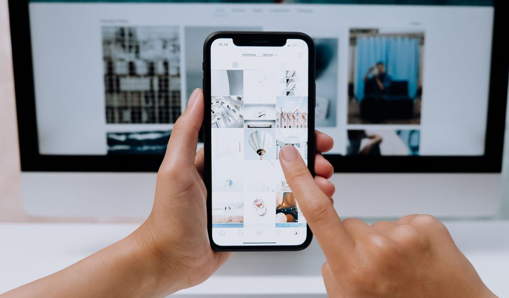 Person holding a phone going through pictures