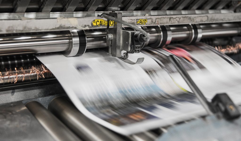 Self-published book being printed on a huge book printing press