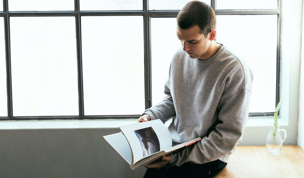 Person flipping through photo book ideas