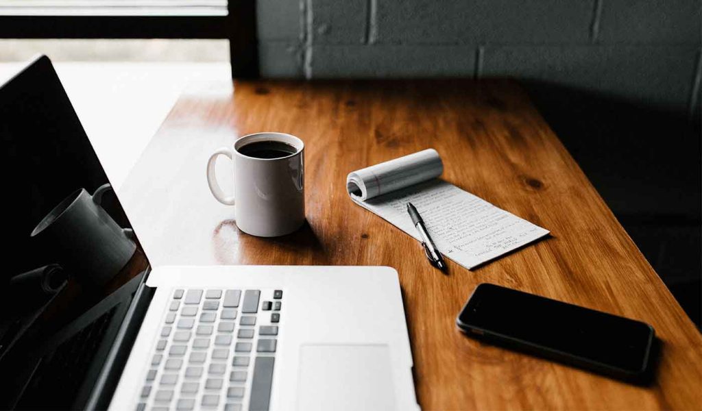 Laptop Computer Next to Coffee Cup, Author Notes & Cell Phone