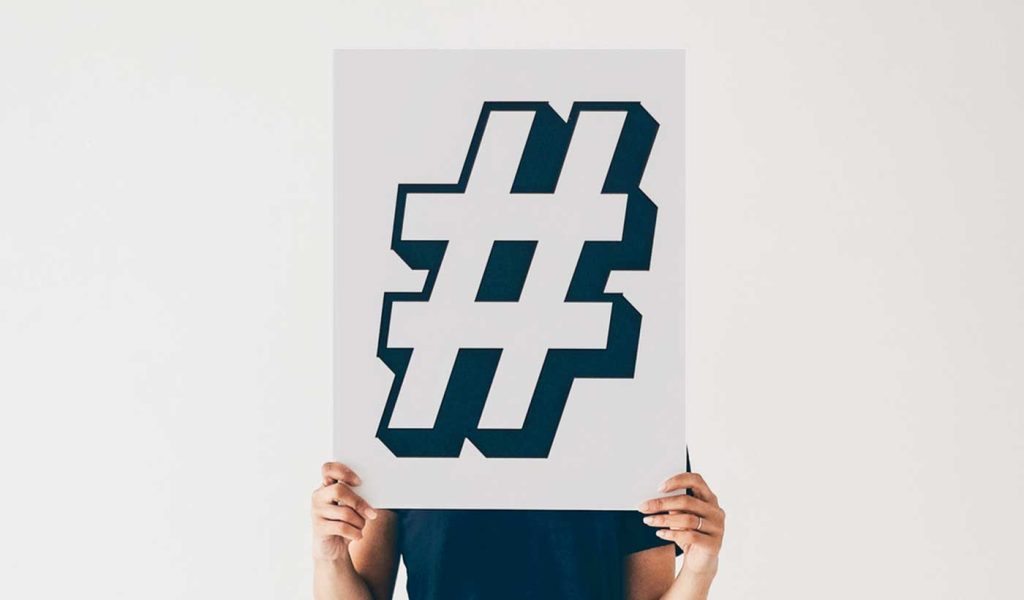 Person holding a hashtag sign